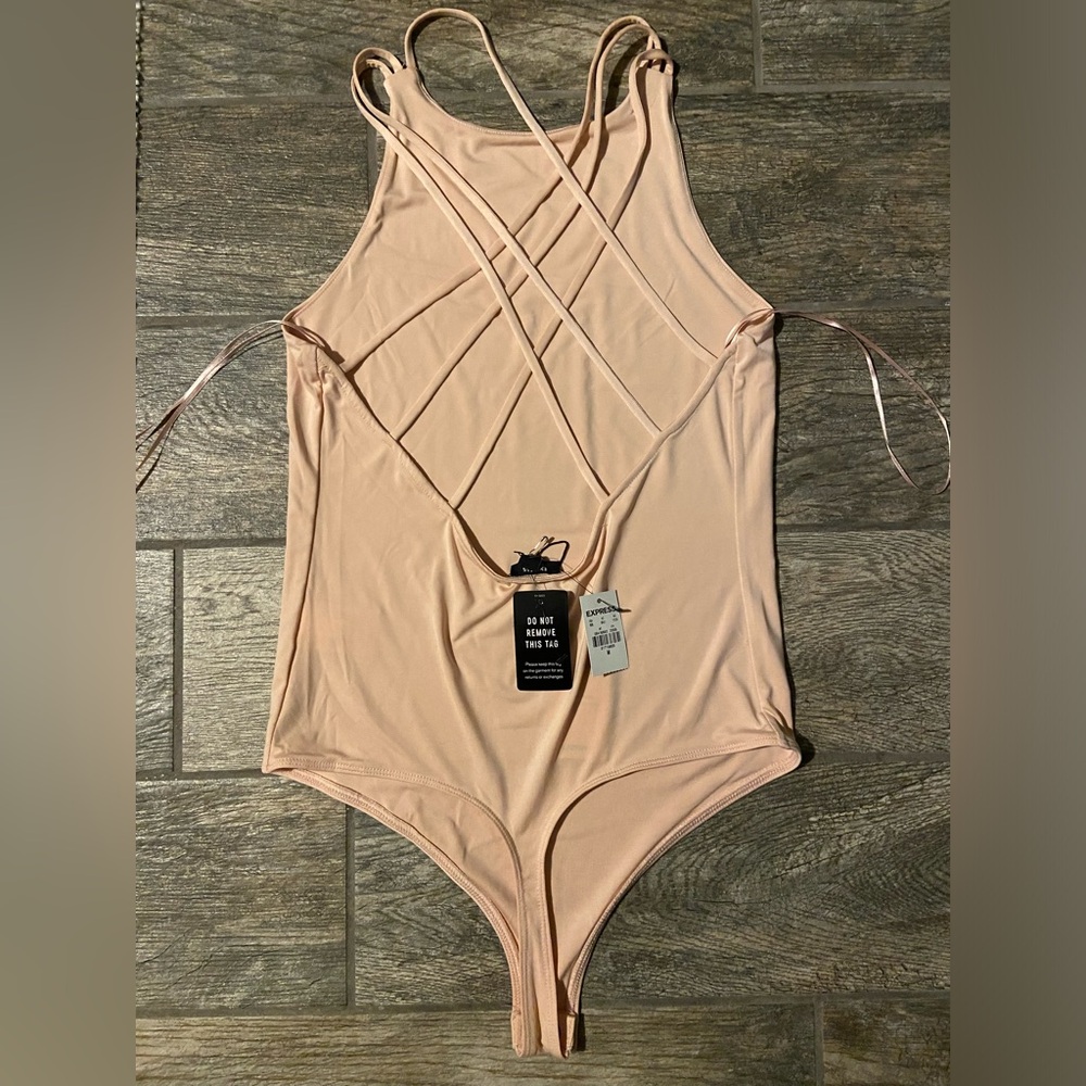 NWT Express Light pink body contour crisscross detailing body suit. Size M